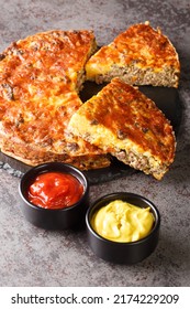 American Light Cheeseburger Pie Served With Sauces Close-up On A Slate Board On The Table. Vertical
