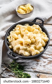 American Mac And Cheese, Macaroni Pasta In Cheesy Sauce. White Wooden Background. Top View