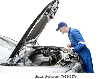 American male mechanic is checking a broken car machine by using a digital tablet, isolated on white background