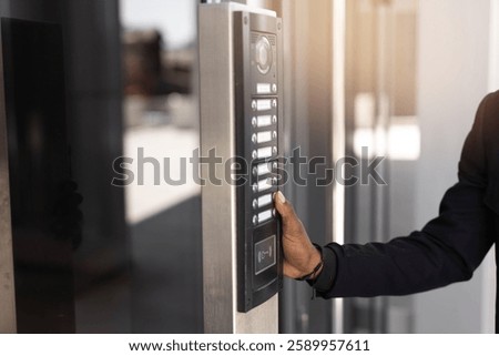american man ringing intercom at home	