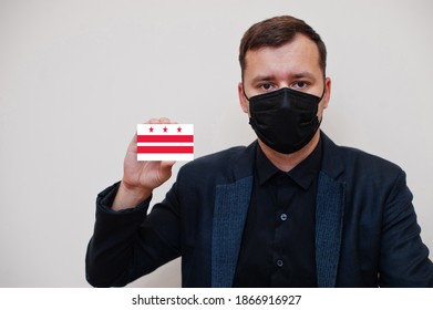 American Man Wear Black Formal And Protect Face Mask, Hold Washington Flag Card Isolated On White Background. USA Cities Coronavirus Covid Concept.