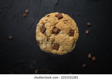 American milk chocolate chip cookies on a dark background. Delicious dessert, close-up