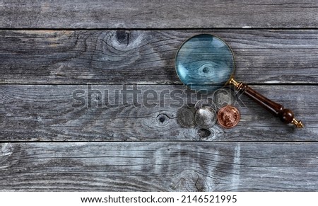 American Morgan silver dollars and one Indian head cent coin on rustic wood table for numismatic investment collecting