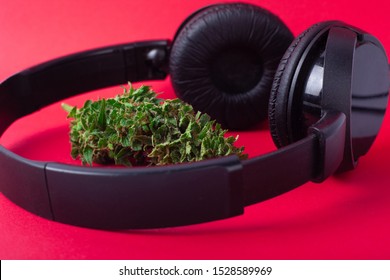 american music industry.headphones and cannabis    on red background