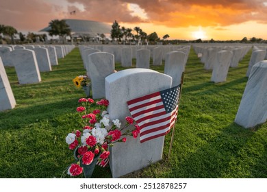 American national military cemetery with rows of white tomb stones with flowers and USA flags on green grass lawn. Memorial Day concept - Powered by Shutterstock