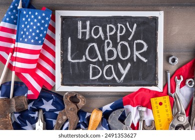 American National Patriotic Workers Happy Labor day Holiday background. Construction and manufacturing tools on wooden background with stars, red white blue striped US flag - Powered by Shutterstock