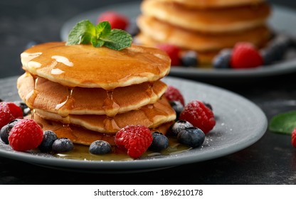 American pancakes with fresh blueberry, raspberry and honey. Healthy morning breakfast - Powered by Shutterstock