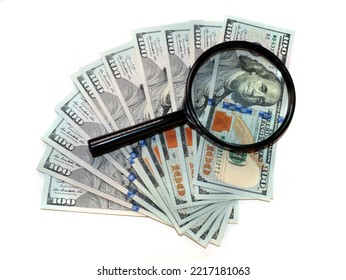 American paper bills dollars and a magnifying glass to check them - Shutterstock ID 2217181063