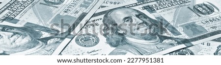 American paper money. 100 dollar and other US bills. Grey-green tinted banner or header. Savings economy and the USA dollar. Public debt and budget