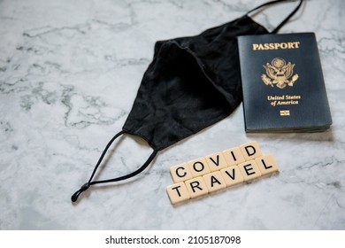 American Passport And Black Face Mask On White Marble Background, Covid Travel, Traveling With Covid, Pandemic Travel