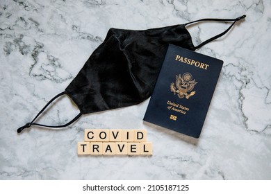 American Passport And Black Face Mask On White Marble Background, Covid Travel, Traveling With Covid, Pandemic Travel