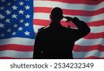 American patriot doing salute hand gesture towards USA flag, feeling pride in serving country. United States army personnel does military greeting gesturing while listening national anthem, camera B