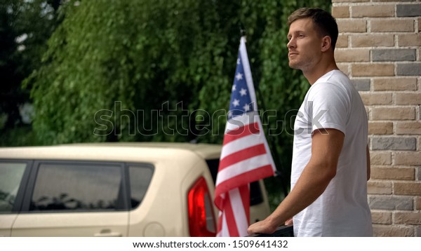 American patriot enjoying beautiful view on\
terrace, resting at weekend\
cottage