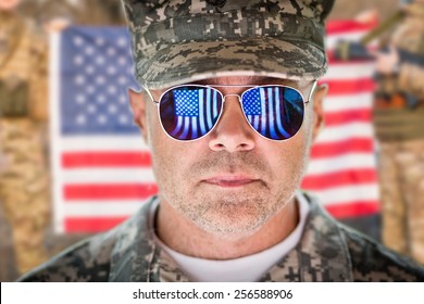 American Patriot Soldier Concept Over American Flag Background. Soft Daylight