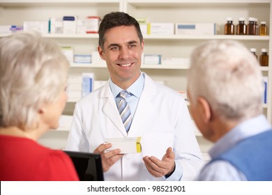 American pharmacist with senior couple in pharmacy - Powered by Shutterstock