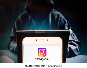 American photo and video-sharing social networking service owned by Facebook, Instagram logo is seen on an Android mobile device with a figure of hacker in the background.
