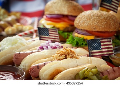 American  Picnic Table  with burgers and hot dogs for holiday 4th of July  - Powered by Shutterstock