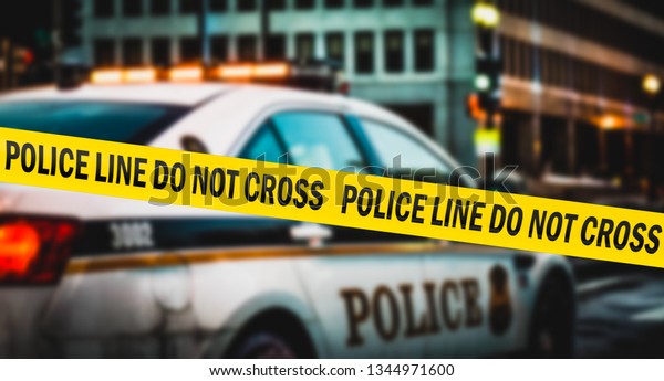 American police tape
hangs near a police
car