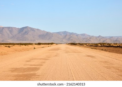 American Road Sandy Dirt Road With Mountains In The Back