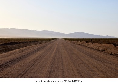 American Road Sandy Dirt Road With Mountains In The Back