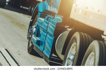 American Road Transportation Industry. Blue Semi Truck on a Interstate Highway Close Up. Ground Shipping.