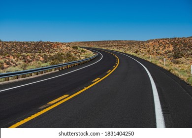 American Roadtrip. Asphalt Road Straight Through The Field With Blue Sky In Autumn