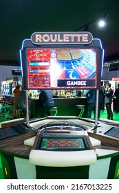 American roulette table working at a casino, blurred players standing around tables on a background. Gaming industry exhibition. November 24, 2021. Kyiv, Ukraine