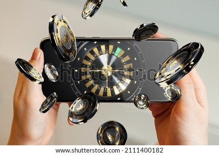 American roulette wheel on smartphone screen, online casino. The concept of gaming applications, internet games, online entertainment. Copy space