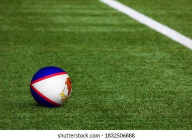 American Samoa flag on ball at soccer field background. National football theme on green grass. Sports competition concept. - Powered by Shutterstock