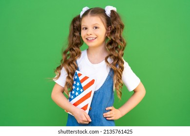 An American Schoolgirl With A Textbook. Good Education In The USA. A Charming Schoolgirl Stands Very Proudly And Holds A Book About The History Of The USA.