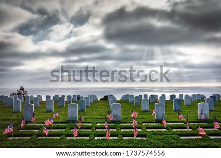 American service members graves with flags for Memorial Day at a southern California cemetery.