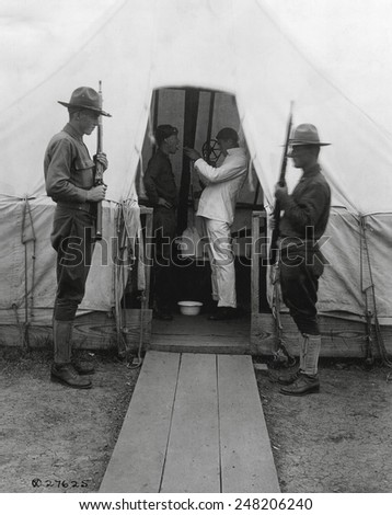 American soldier gets throat sprayed to prevent influenza. Dec. 1918. Medical tent at Love Field, Dallas, Texas, during the 1918-19 'Spanish' Influenza pandemic.