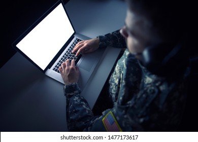 American Soldier In Military Uniform Using High Tech Computer In Headquarters Intelligence Center. Focus On Laptop Display.