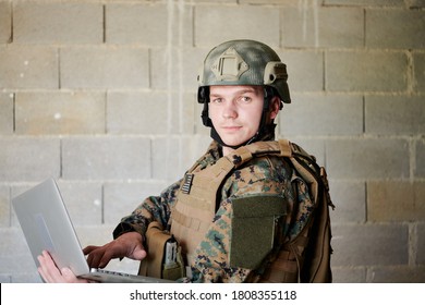 American Soldier In Military Uniform Using Laptop Computer For Drone Controlling And To Stay In Contact With Friends And Family