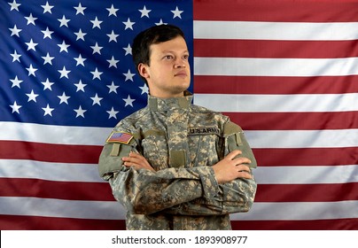 American Soldier On The Background Of The Flag. Portrait Of A US Army Soldier.