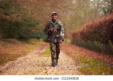 American Soldier In Uniform Carrying Kitbag Returning Home On Leave