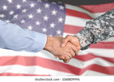 American Soldier In Uniform And Civil Man Handshake