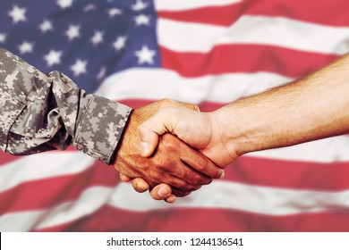 American Soldier In Uniform And Civil Man Handshake