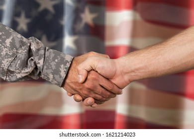 American Soldier In Uniform And Civil Man Handshake