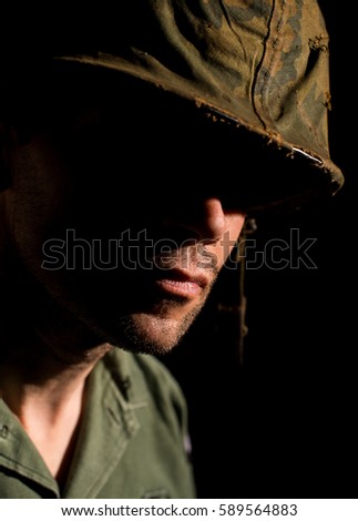 American soldier from the Vietnam War with half face in shadow.