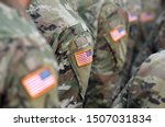 American Soldiers and Flag of USA on soldiers arm. US Army. Veteran Day