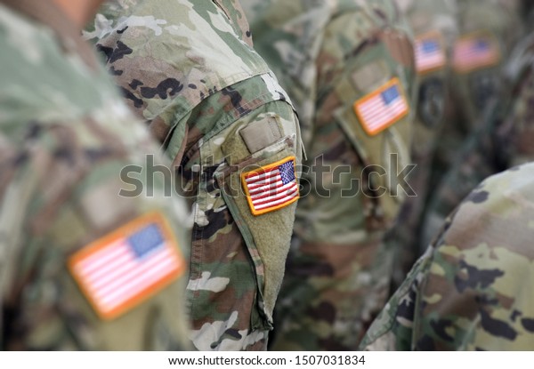 American Soldiers and Flag of USA on soldiers arm. US\
Army. Veteran Day
