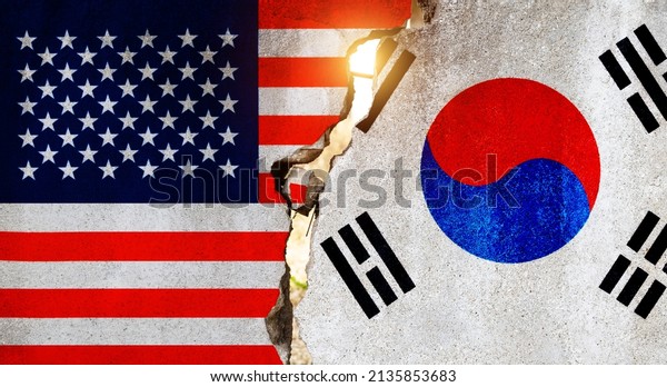 American\
and South Korean flags on broken cracked\
wall.