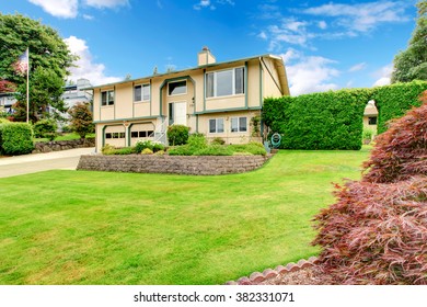 American Split Level Home With Large Grassy Front Yard.