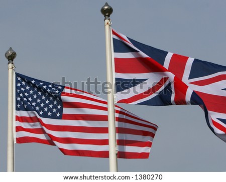 The American Stars and stripes flying from a flagpole next to the Union Jack of Great Britain