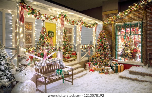 American style\
Christmas studio house with fake snow, a bench, a snowman Christmas\
trees and a lot of\
details