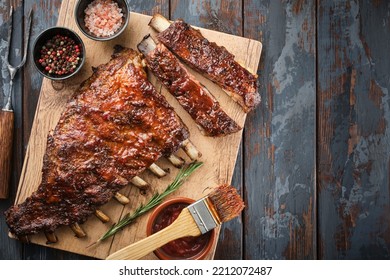 American style pork ribs. Delicious smoked pork spareribs glazed in BBQ sauce. Top view. Copyspace.