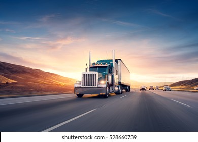 American style truck on freeway pulling load. Transportation theme. Road cars theme.