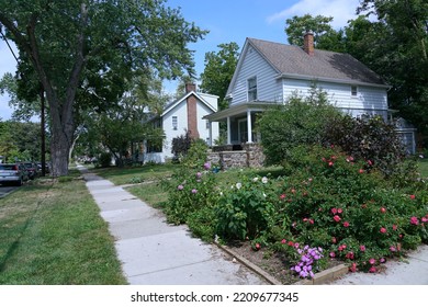 American Suburban Street With Two Story Detached Houses With White Siding