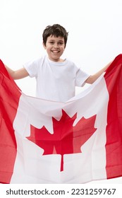 American teenage boy carries Canadian flag, celebrates Independence Day of Canada, July 1, isolated over white background, with advertising space for text. Citizenships Patriotism Emigration Concept - Shutterstock ID 2231259767